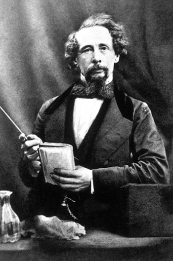 Charles Dickens holding a manuscript